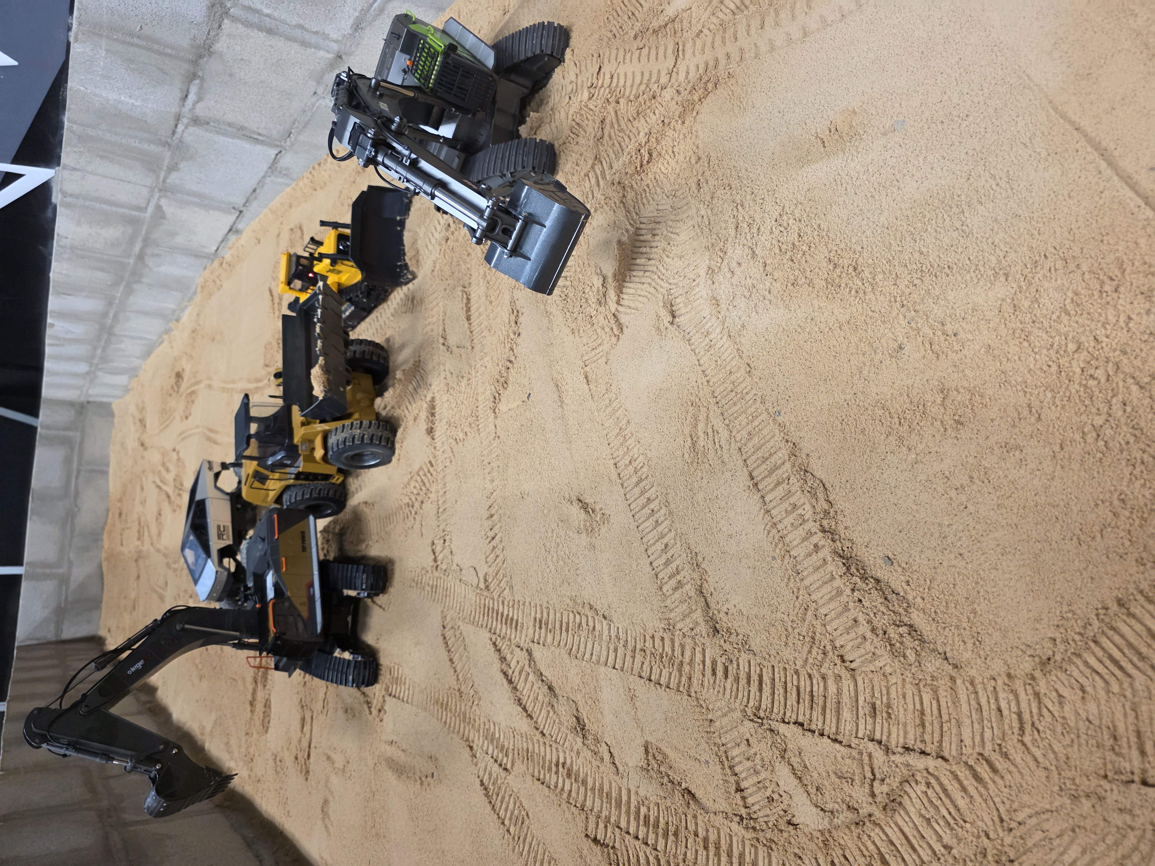 RC excavator in the sand pit