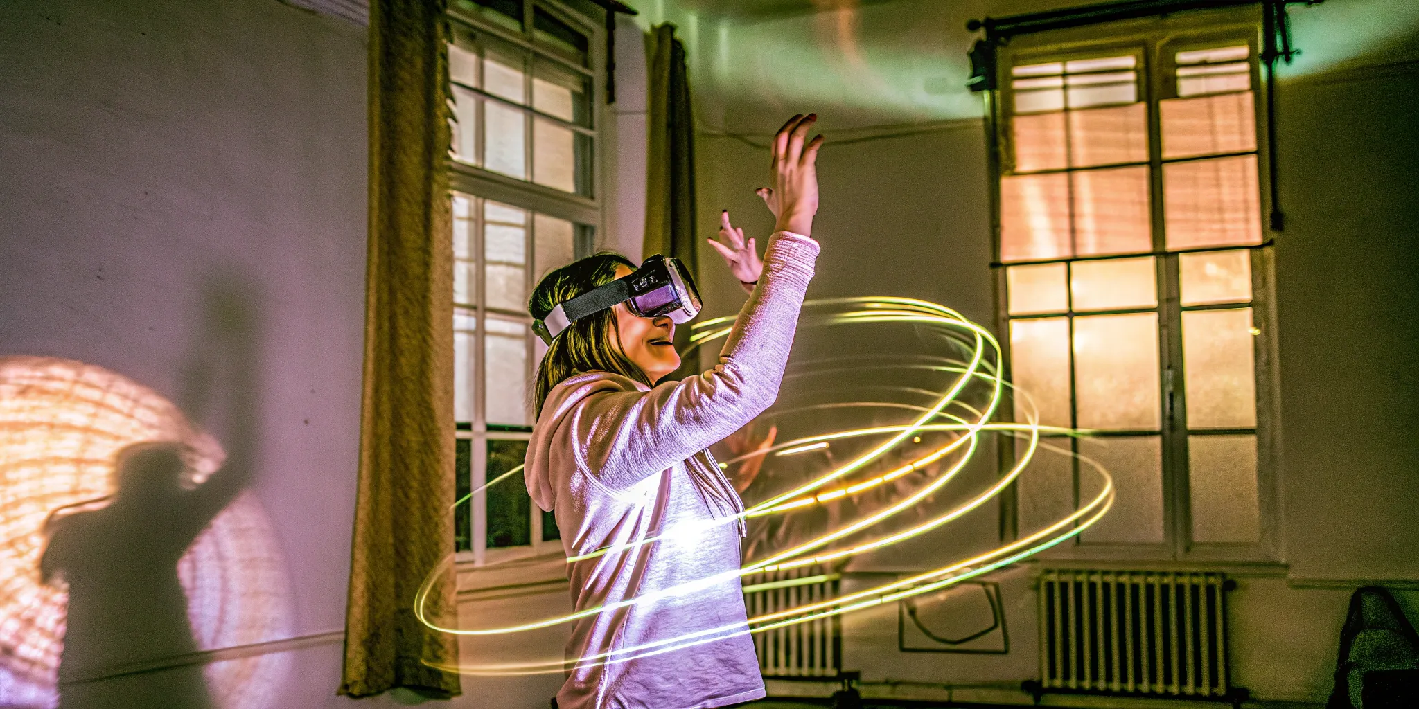Woman experiencing immersive VR with light trails showing movement in Austin VR arcade